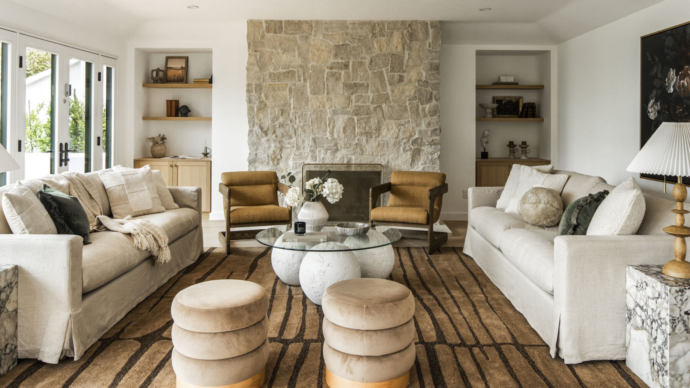 Sunlit Los Angeles living room with a stone fireplace