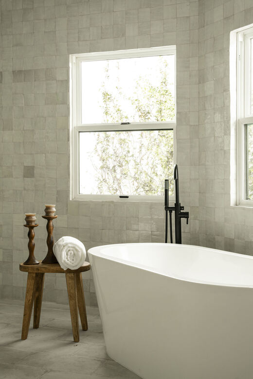 Soaking tub against zellige tile